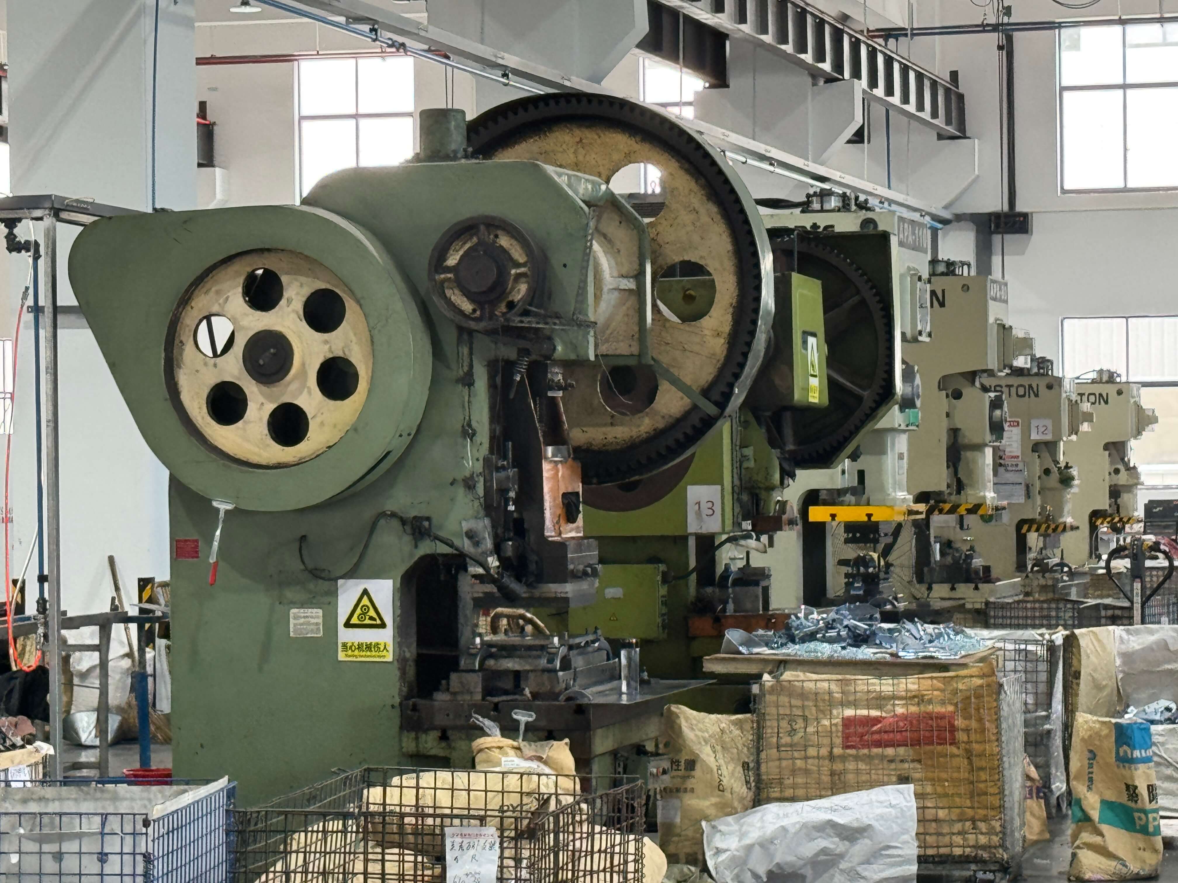 High-speed stamping press forming garage door hardware at the Welllift factory
